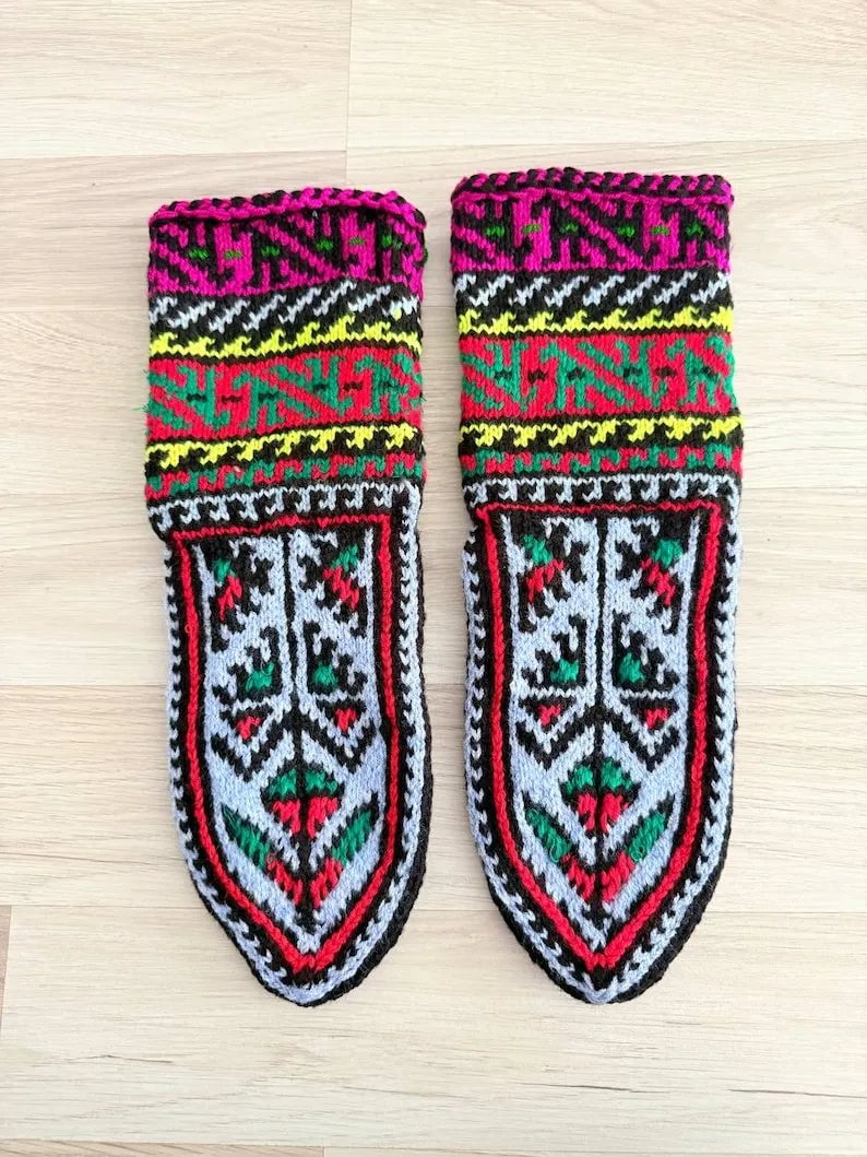 A hoodie on a gray floor with harsh industrial lighting